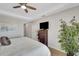 This bedroom has a ceiling fan, flat screen TV, dresser, and decorative plant at 2001 Bal Harbor Blvd # 2301, Punta Gorda, FL 33950