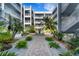 Lush courtyard with a water fountain and manicured landscaping surrounded by condo units at 2001 Bal Harbor Blvd # 2301, Punta Gorda, FL 33950