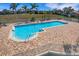 Community pool with spacious deck featuring tables, chairs, and lounge chairs at 2001 Bal Harbor Blvd # 2301, Punta Gorda, FL 33950