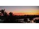 Beautiful sunset view over the lake with palm trees and a community pier at 2001 Bal Harbor Blvd # 2301, Punta Gorda, FL 33950