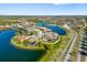 Beautiful aerial view of a lakeside home with a lush landscaped yard in a vibrant community at 20078 Elegante Ct, Venice, FL 34293