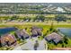 An aerial view of the property showcasing the surrounding landscaping, nearby lakes, and neighborhood at 20078 Elegante Ct, Venice, FL 34293