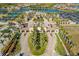 A high angle shows the community gate entrance, pool and parking at 20078 Elegante Ct, Venice, FL 34293