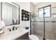 Modern bathroom showcasing a marble countertop, glass shower, and stylish tic-tac-toe shelf at 20078 Elegante Ct, Venice, FL 34293