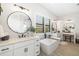 Bright, stylish bathroom showcasing double vanities, soaking tub, and decorative mirrors at 20078 Elegante Ct, Venice, FL 34293