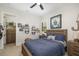 Cozy bedroom featuring a wood bed frame, blue bedding, and decorative wall art at 20078 Elegante Ct, Venice, FL 34293