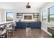 Bonus room features a bar area with blue cabinets, open shelving, and unique decor elements at 20078 Elegante Ct, Venice, FL 34293