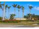 Grand Paradiso community sign surrounded by palm trees and colorful landscaping at 20078 Elegante Ct, Venice, FL 34293