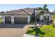 Beautiful single-Gathering home with a tile roof, three car garage, and lovely landscaping at 20078 Elegante Ct, Venice, FL 34293