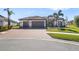 Beautiful single-Gathering home with a tile roof, three car garage, and lovely landscaping at 20078 Elegante Ct, Venice, FL 34293