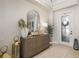 Inviting foyer featuring a stylish mirror, console table, decorative lamps, and elegant front door at 20078 Elegante Ct, Venice, FL 34293