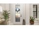 Elegant foyer featuring decorative glass front door and sidelight, paired with white trim and light walls at 20078 Elegante Ct, Venice, FL 34293