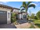 Beautiful home exterior with stone accents, landscaped yard, and a welcoming walkway at 20078 Elegante Ct, Venice, FL 34293