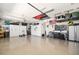 Well-organized garage with storage cabinets, tool organizers and epoxy floor at 20078 Elegante Ct, Venice, FL 34293