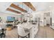 Open-concept kitchen featuring a spacious island, pendant lighting, stainless appliances, and wood beam ceiling at 20078 Elegante Ct, Venice, FL 34293