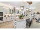 Bright kitchen with white cabinets, granite countertops, stainless steel appliances, and a large center island at 20078 Elegante Ct, Venice, FL 34293