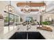 Close up of the kitchen island, showcasing the granite countertops, sink, and view of the living room at 20078 Elegante Ct, Venice, FL 34293