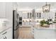 Kitchen with stainless steel appliances, white cabinetry, and a large island with seating at 20078 Elegante Ct, Venice, FL 34293