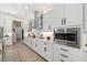 Gourmet kitchen with modern stainless steel appliances, white cabinets, and granite countertops at 20078 Elegante Ct, Venice, FL 34293