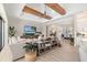 Large living room featuring modern decor, wood beams, a ceiling fan, and a view of the open-concept kitchen at 20078 Elegante Ct, Venice, FL 34293