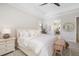 Bright main bedroom with a wooden bench, white furnishings and access to the main bathroom at 20078 Elegante Ct, Venice, FL 34293