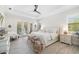 Bright main bedroom featuring white furnishing with a ceiling fan and access to the patio at 20078 Elegante Ct, Venice, FL 34293