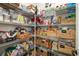 Walk-in pantry with wire shelving, stocked with a variety of items in baskets and containers at 20078 Elegante Ct, Venice, FL 34293