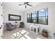 Bright sitting room with large windows, two armchairs, wood-look tile flooring, and stylish decor at 20078 Elegante Ct, Venice, FL 34293