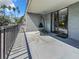 Relaxing balcony area featuring a chair swing and access to the interior through sliding glass doors at 201 W Laurel St # 209, Tampa, FL 33602