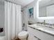 Bathroom features a shower with a striped curtain, subway tile, and granite countertops at 201 W Laurel St # 209, Tampa, FL 33602