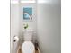 Compact bathroom with a toilet, artwork, and a small potted plant on the tank at 201 W Laurel St # 209, Tampa, FL 33602