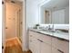 Modern bathroom featuring marble countertops, wood-look tile flooring, and a glass shower enclosure at 201 W Laurel St # 209, Tampa, FL 33602