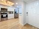 Inviting kitchen featuring stainless steel appliances, modern cabinets, and wood-look floors, adjacent to entrance at 201 W Laurel St # 209, Tampa, FL 33602