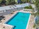 Aerial view of a community pool surrounded by lounge chairs and tables, perfect for relaxation at 201 W Laurel St # 209, Tampa, FL 33602