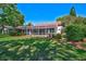 Lovely backyard view showcasing a screened-in lanai and landscaped grounds at 2081 Timucua Trl, Nokomis, FL 34275