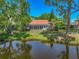 Scenic backyard featuring an enclosed lanai and a serene water view at 2081 Timucua Trl, Nokomis, FL 34275