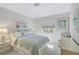 Cozy bedroom featuring seaside decor, including light blue bedding and nautical artwork at 2081 Timucua Trl, Nokomis, FL 34275