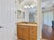 Bathroom with granite vanity, wood cabinets, and view into the water closet at 20909 Loggia Ct, Venice, FL 34293