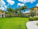 Gran Paradiso's clubhouse is surrounded by greenery and swaying palm trees at 20909 Loggia Ct, Venice, FL 34293