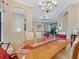 Elegant dining room showcasing a wooden table with upholstered chairs and a view of the spacious living area at 20909 Loggia Ct, Venice, FL 34293