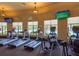 A modern gym with treadmills, elliptical machines, and flat-screen TVs at 20909 Loggia Ct, Venice, FL 34293