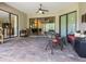 Covered lanai features brick pavers, comfortable seating, and views of the backyard and home at 20909 Loggia Ct, Venice, FL 34293