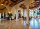 A luxurious lobby with high ceilings, elegant columns, and travertine flooring at 20909 Loggia Ct, Venice, FL 34293