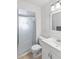 Clean bathroom featuring a glass shower door, white toilet and sink, and a mirror at 2118 Wells Av, Sarasota, FL 34232