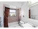 Cozy bathroom showcasing a shower-tub combo with a tiled surround and vanity at 2118 Wells Av, Sarasota, FL 34232