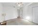 Well-lit bedroom features a ceiling fan, closet, and neutral-colored carpeting at 2118 Wells Av, Sarasota, FL 34232