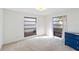 Bright bedroom featuring neutral carpet, white walls, and two large windows at 2118 Wells Av, Sarasota, FL 34232