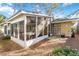 Cozy screened-in porch connected to the main house creating a seamless indoor-outdoor living space at 2118 Wells Av, Sarasota, FL 34232