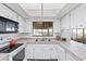 Bright kitchen with white cabinets, stainless steel sink and natural light at 2118 Wells Av, Sarasota, FL 34232