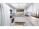 Kitchen featuring white cabinets, tile countertops, white appliances and natural light at 2118 Wells Av, Sarasota, FL 34232